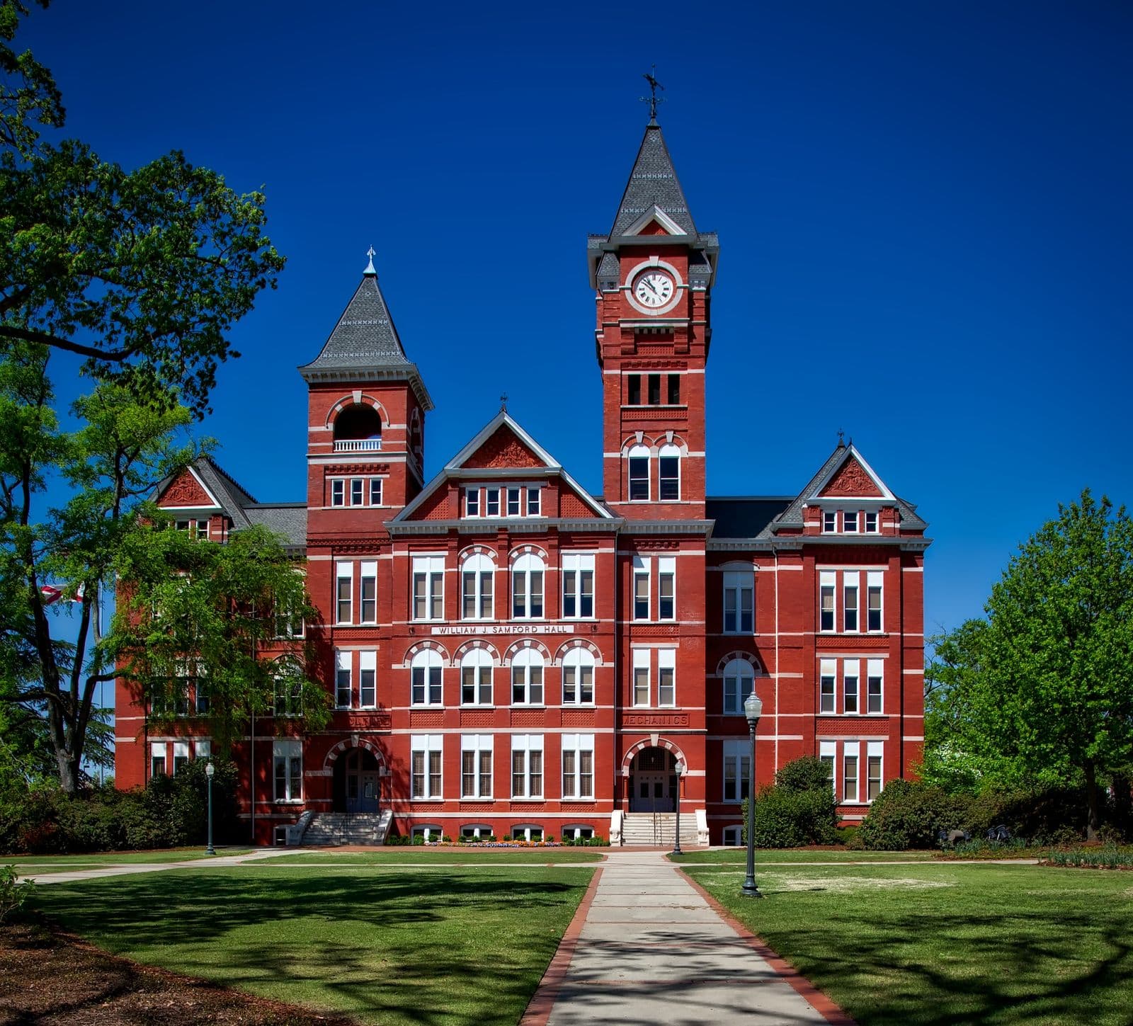 Historic red-brick campus building with a clock tower